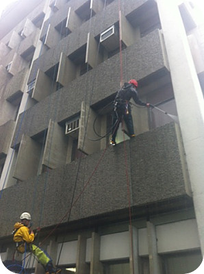 Strings Attached water blasting the Hamilton Central Police Station<